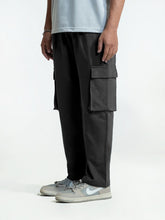 Person wearing black cargo trouser on a white background
