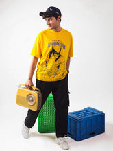 male model wearing yellow wolverine oversized graphic t shirt showing the right side of the t shirt