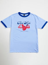 Light blue cote d azur oversized graphic t-shirt with red fruit design and text on a white background