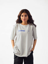 female model wearing grey evolution oversized graphic t shirt showing front of the t shirt