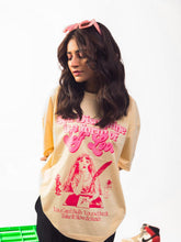 female model wearing beige in love with myself oversized graphic t shirt showing the front of the t shirt