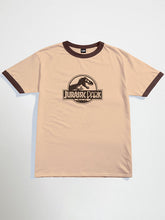 Beige Jurassic park oversized graphic t-shirt with brown ringer design featuring 'Jurassic Park' logo on a light gray background