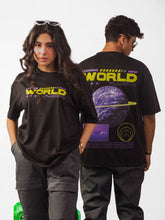 Male and Female model wearing black loading new world oversized graphic t shirt in which male model showing the back side while female model showing the front side of the t shirt