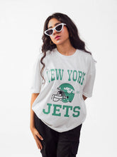 female model wearing white newyork jets oversized graphic t shirt showing the front side of the t shirt