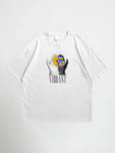 White vibrant oversized graphic t-shirt with a graphic design of hands holding a sun and the word 'Vibrant' on a white background