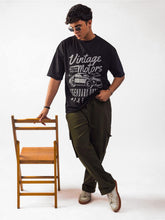 male model wearing black vintage motors oversized graphic t shirt showing front side