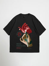 Black world peace oversized graphic t-shirt with a graphic of a hand holding a red rose on a white background