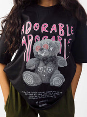 Female model wearing black oversized graphic t shirt detailed view Attire Essentials