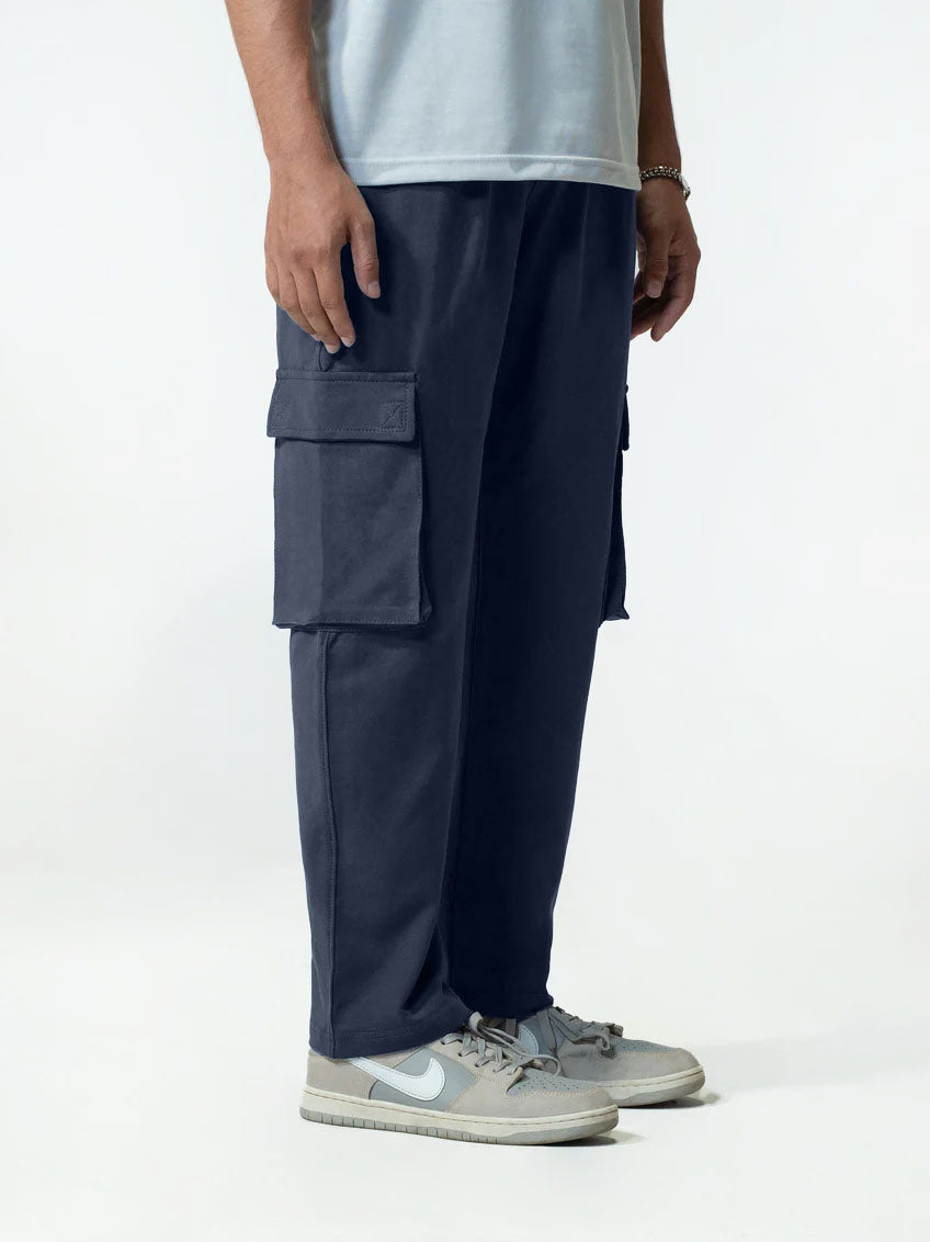 Person wearing navy cargo trouser on a white background