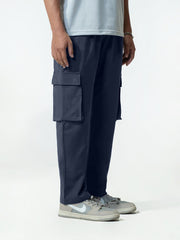Person wearing navy cargo trouser on a white background