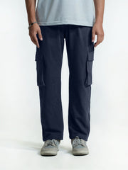 Person wearing navy cargo trouser on a white background