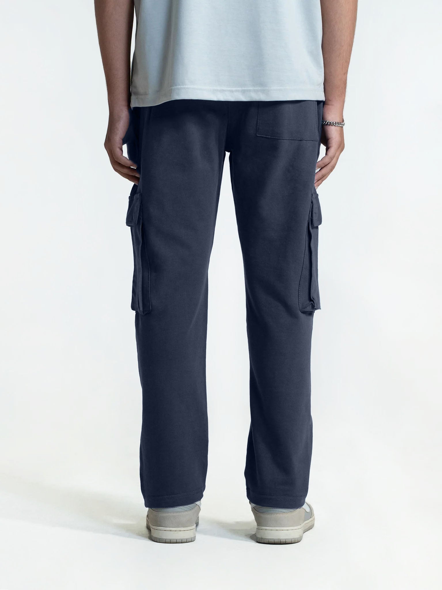 Person wearing navy cargo trouser on a white background