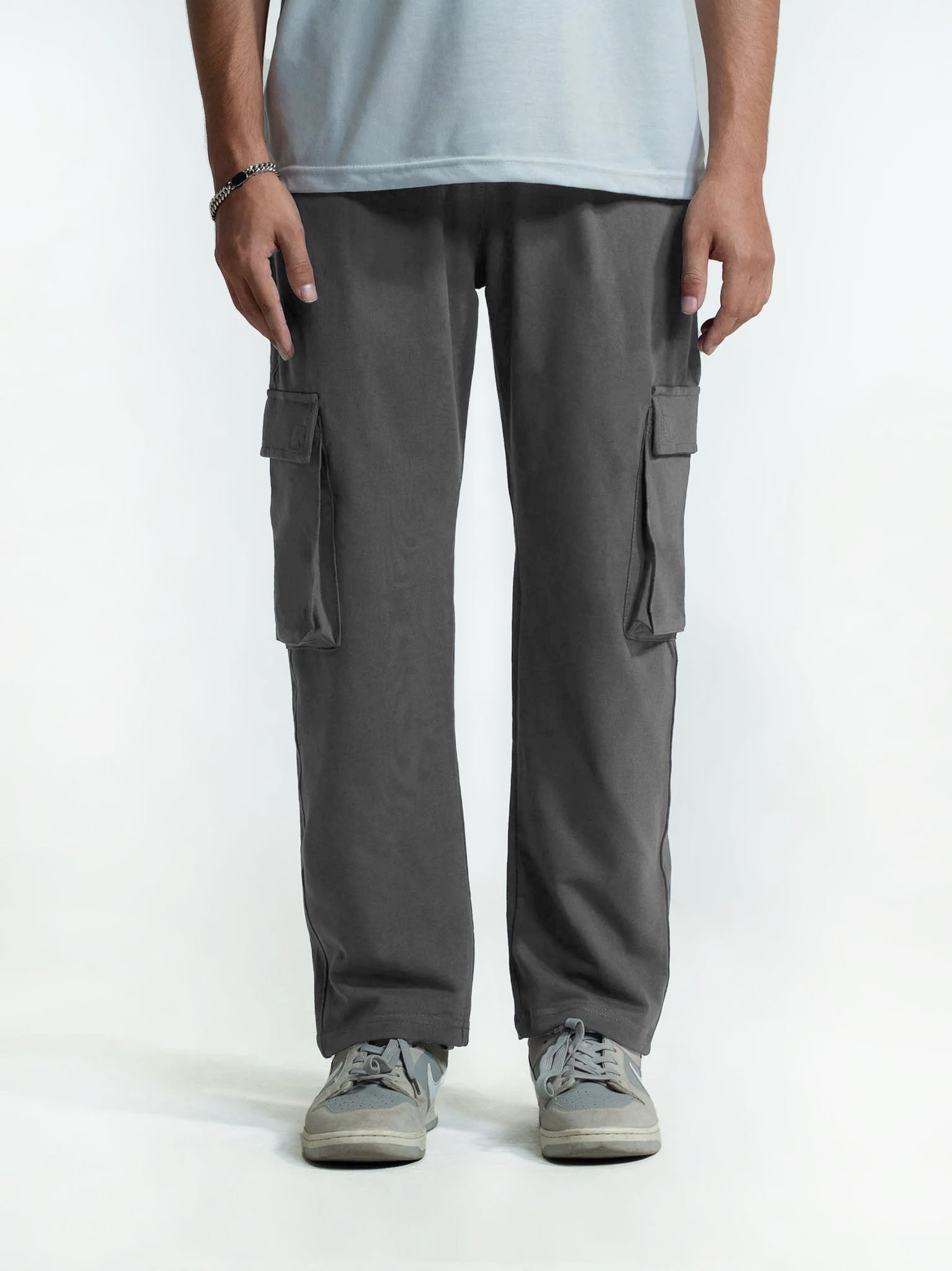 Person wearing gray cargo trouser on a white background