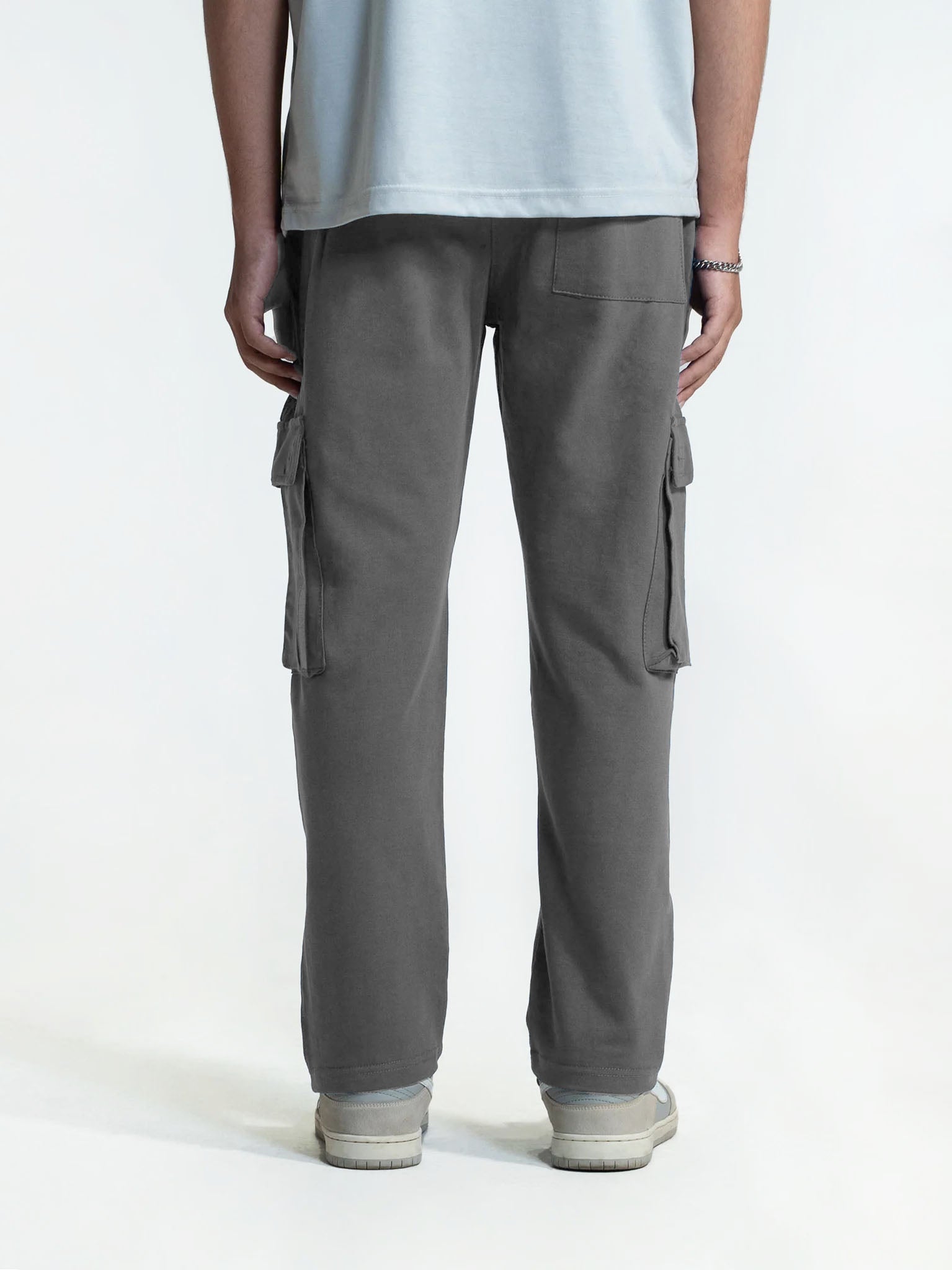Person wearing gray cargo trouser on a white background