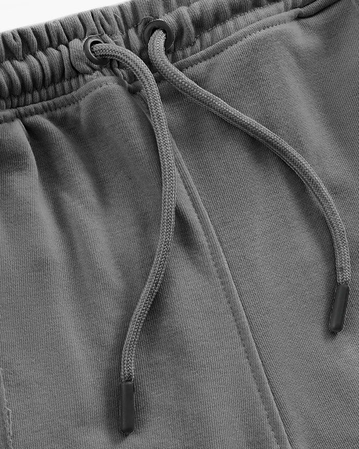 Close-up of gray straight pleated trouser with a drawstring