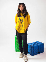 female model wearing yellow wolverine oversized graphic t shirt showing the front of the t shirt 