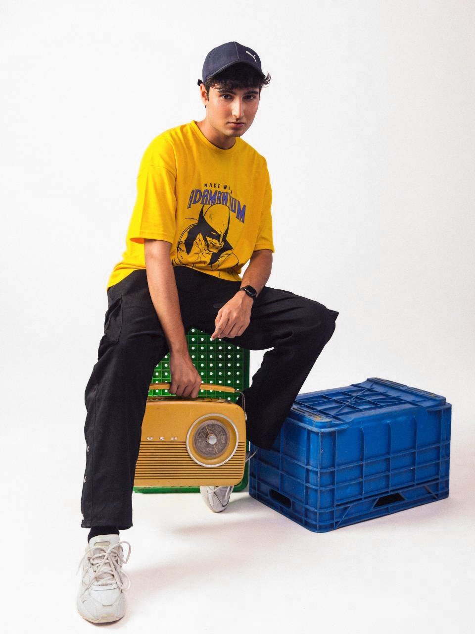 male model wearing yellow wolverine oversized graphic t shirt showing the right side of the t shirt 