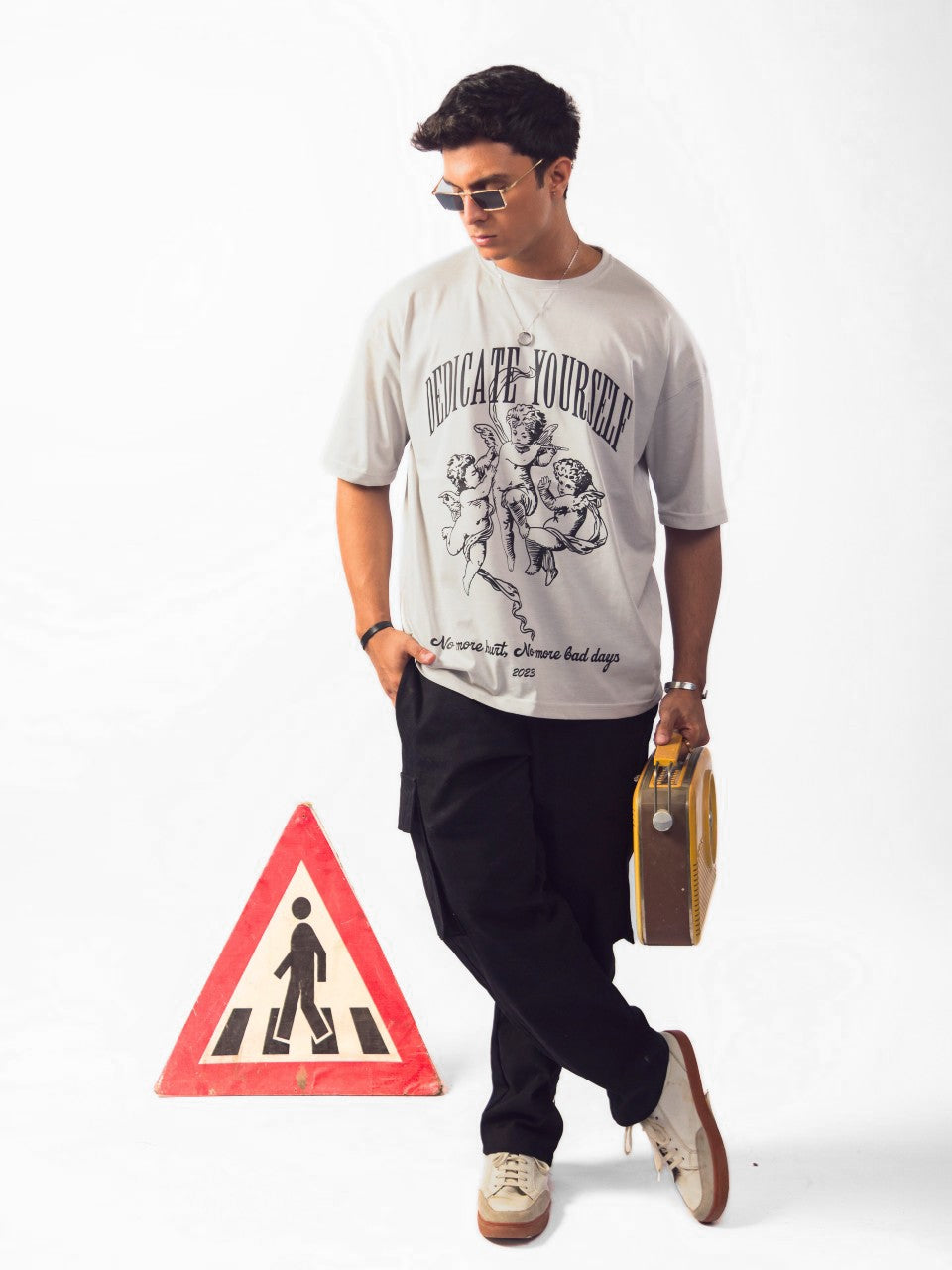 Male model wearing grey dedicate yourself oversized graphic t shirt showing front view Attire Essentials