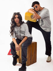Female and male model wearing grey dedicate yourself oversized graphic t shirt showing side view Attire Essentials