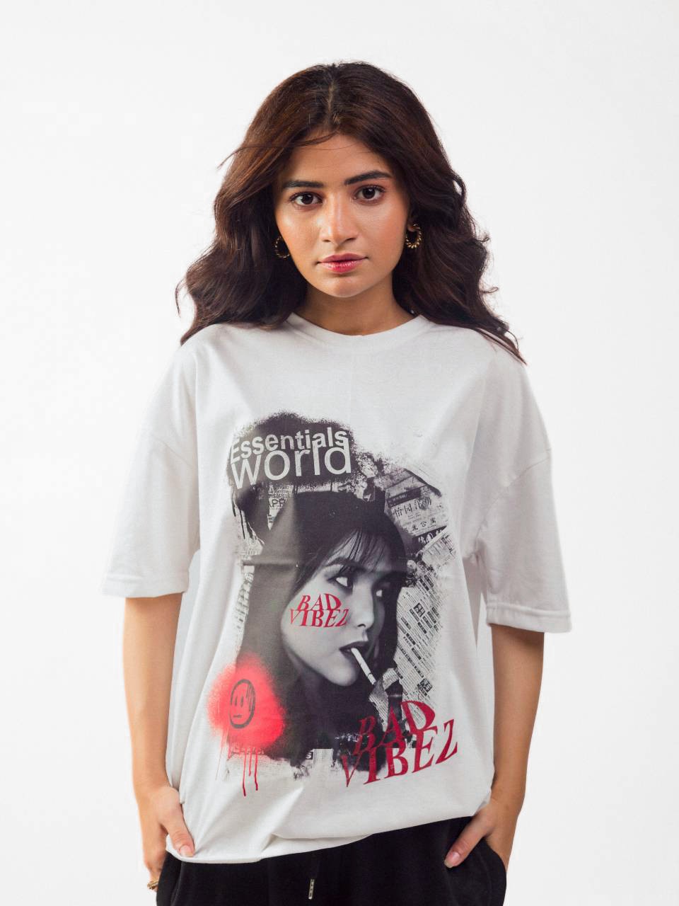 female model wearing white essentials oversized graphic t shirt showing the front side in a standing position