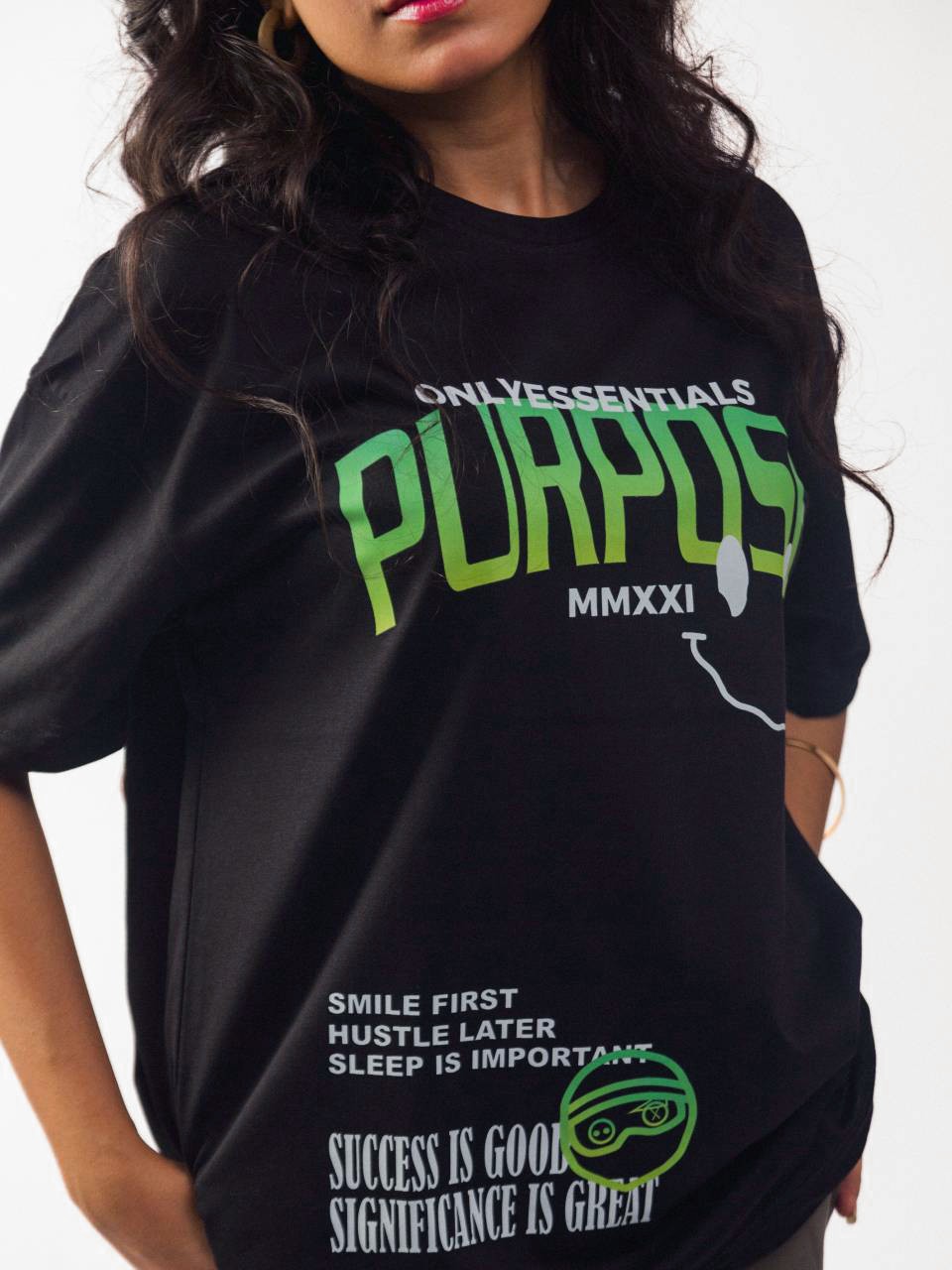 female model wearing black essentials purpose oversized graphic t shirt showing the front in detailed view