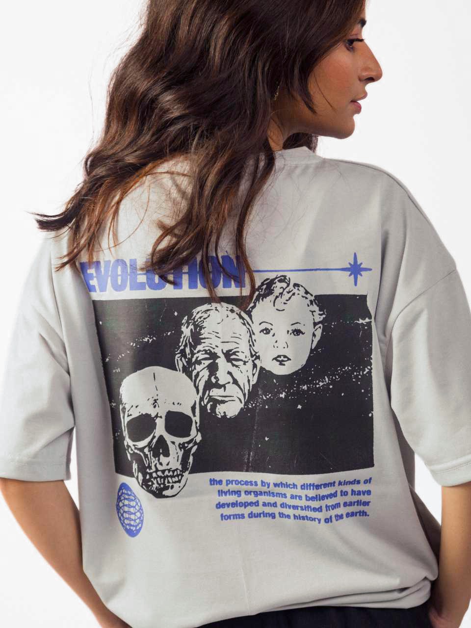 female model wearing grey evolution oversized graphic t shirt showing back of the t shirt in a detailed view
