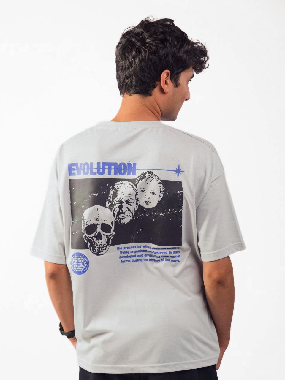 male model wearing grey evolution oversized graphic t shirt showing back of the t shirt