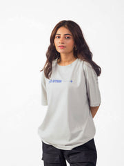 female model wearing grey evolution oversized graphic t shirt showing front of the t shirt while standing