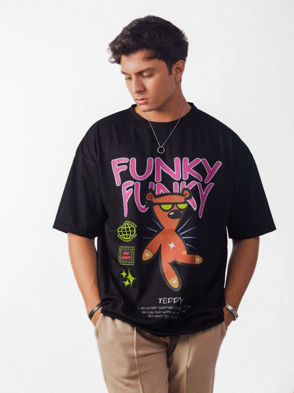 Male model wearing black funky funky oversized graphic t shirt showing front view Attire Essentials
