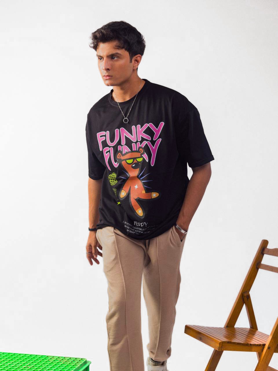 Male model wearing black funky funky oversized graphic t shirt showing front view while walking Attire Essentials