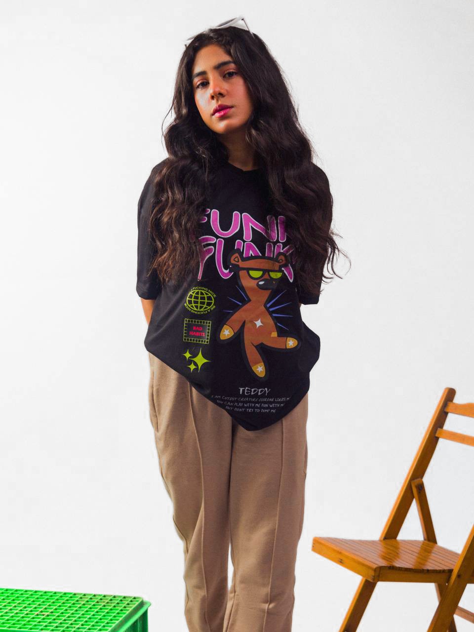 Female model wearing black funky funky oversized graphic t shirt showing front view Attire Essentials