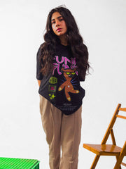 Female model wearing black funky funky oversized graphic t shirt showing front view Attire Essentials