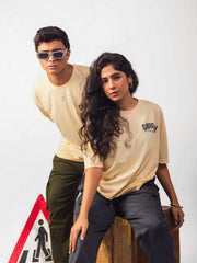 Male and female model wearing beige gangsta oversized graphic t shirt showing the front view Attire Essentials