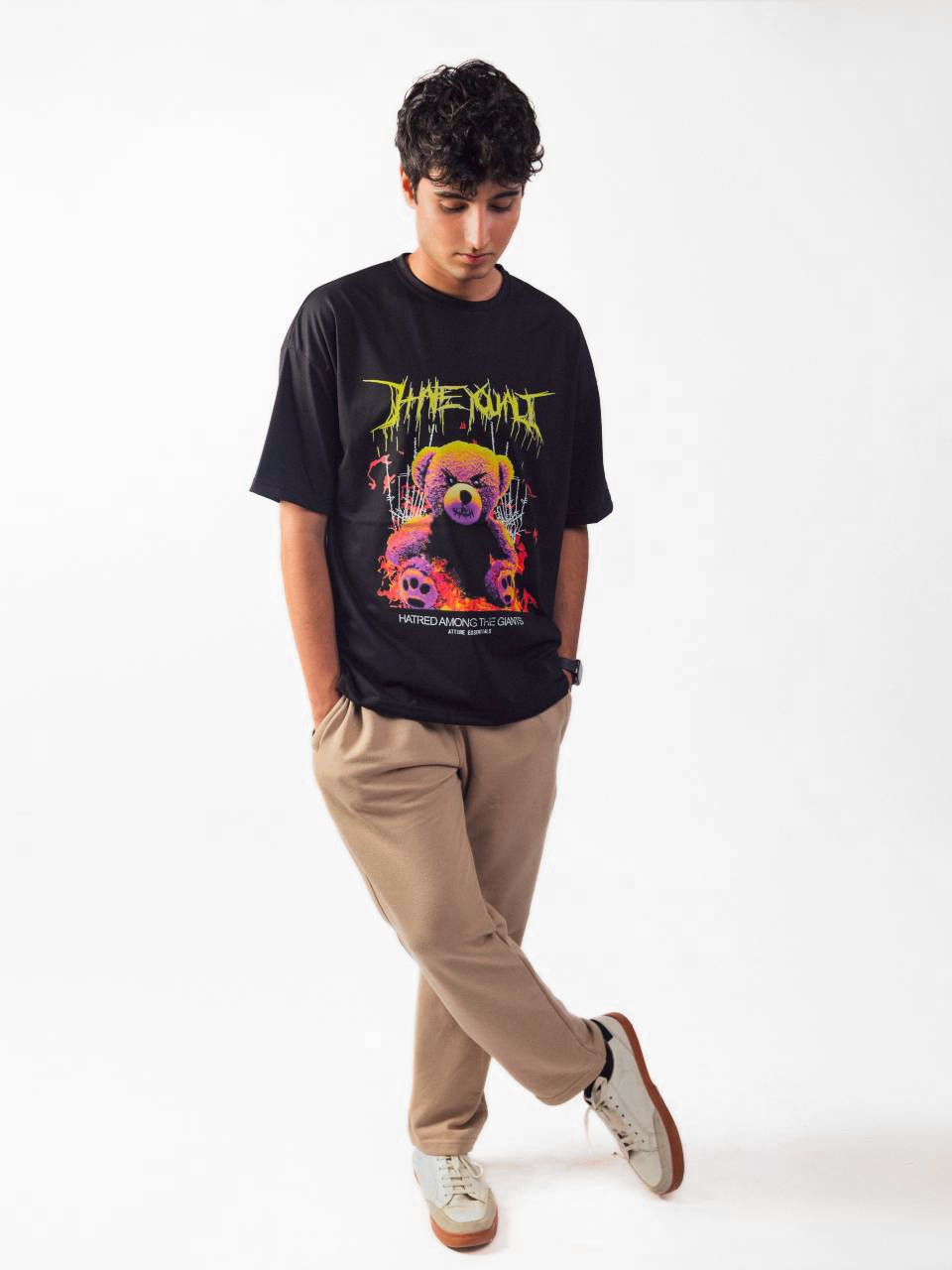 male model wearing black hate you all oversized graphic t shirt showing the front of the t shirt while standing