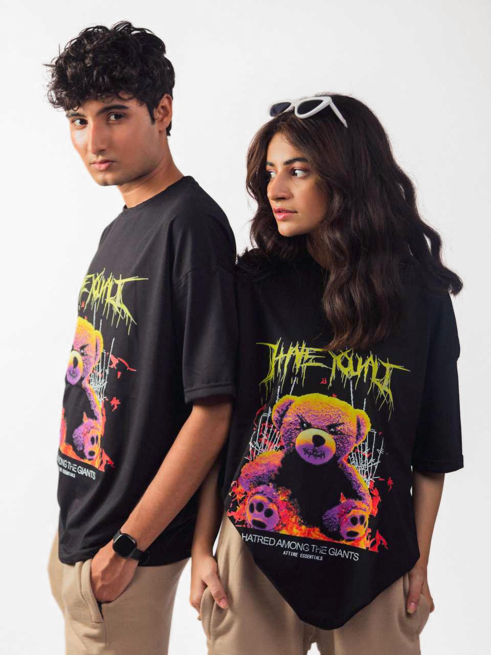 female and male model wearing black hate you all oversized graphic t shirt showing the front and side view of the t shirt