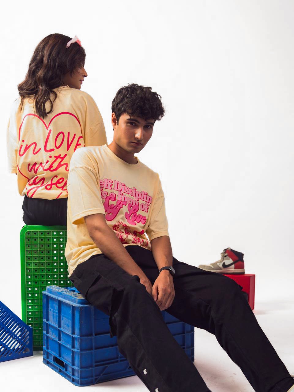 male and female model wearing beige in love with myself oversized graphic t shirt showing front and back of the t shirt