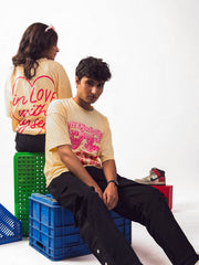 male and female model wearing beige in love with myself oversized graphic t shirt showing front and back of the t shirt