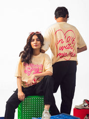 male and female model wearing beige in love with myself oversized graphic t shirt showing front and back of the t shirt, female model showing front while male model showing back