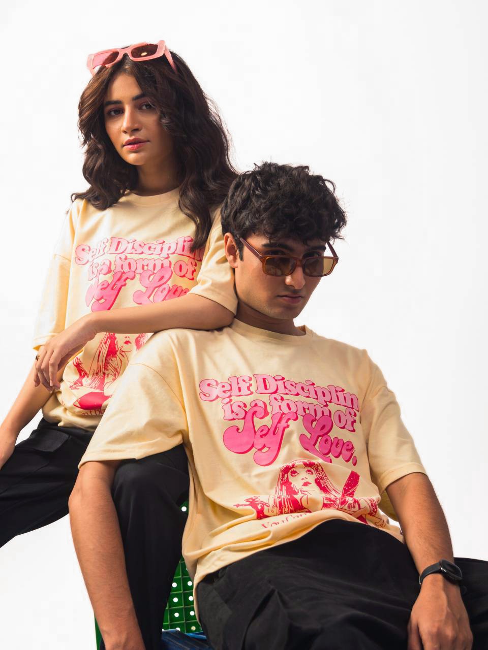 male and female model wearing beige in love with myself oversized graphic t shirt showing front of the t shirt