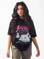 female model wearing black joy in the journey oversized graphic t shirt showing the front side of the t shirt