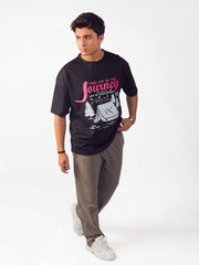 male model wearing black joy in the journey oversized graphic t shirt showing the side view of the t shirt