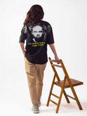 Female model wearing black kanye west oversized graphic t shirt showing the back side of the t shirt Attire Essentials