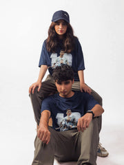 male and female model showing blue lionel messi oversized graphic t shirt while sitting