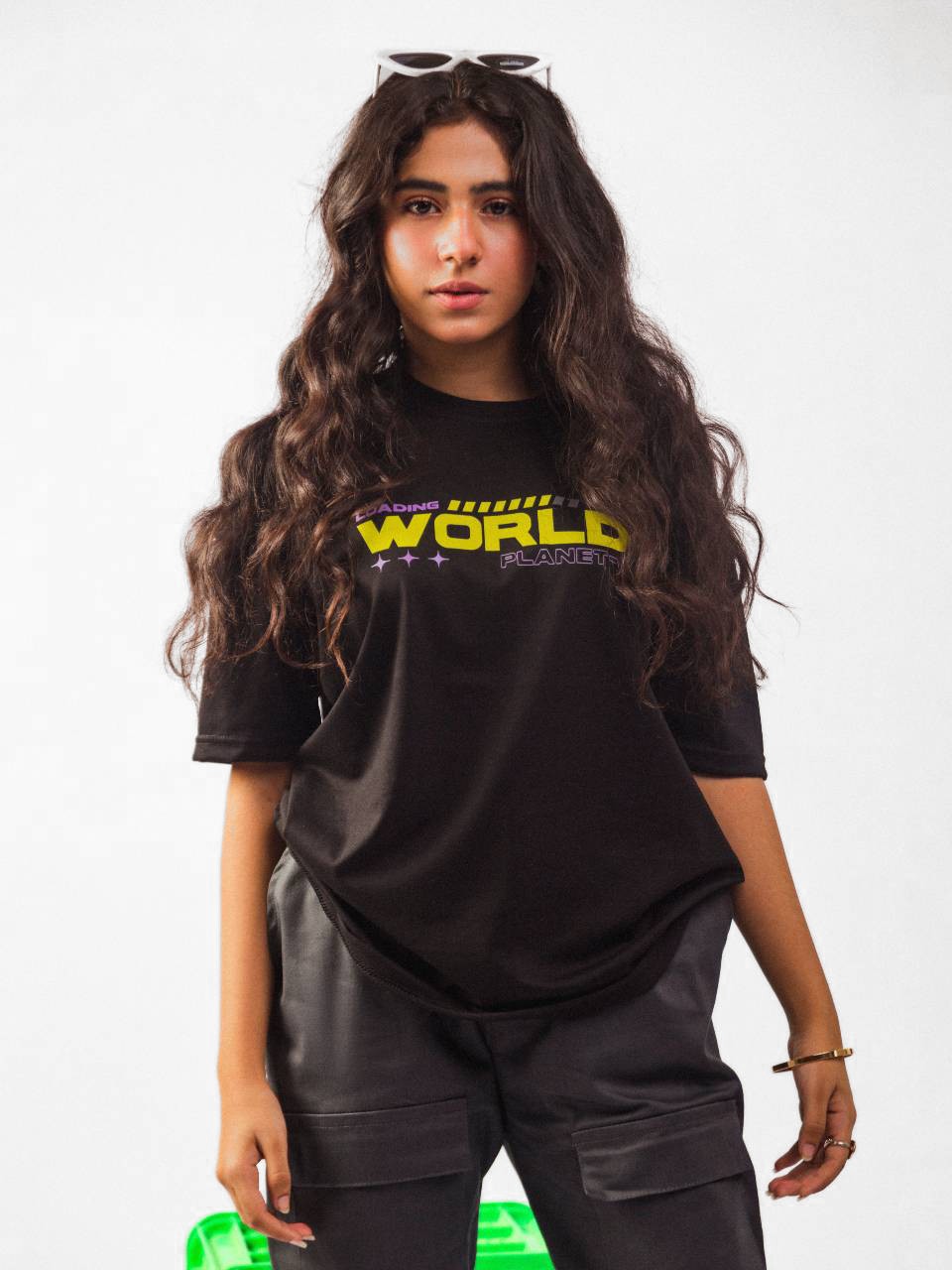 Female model wearing black loading new world oversized graphic t shirt in which female model showing the front view of the t shirt