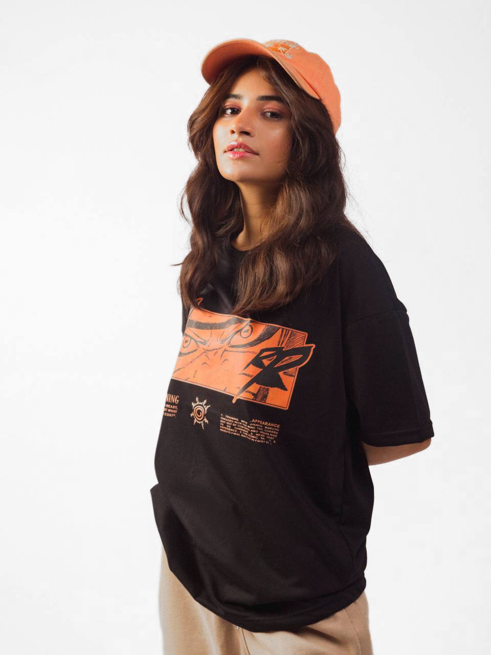 male model wearing black naruto awakening oversized graphic t shirt showing side view of the t shirt