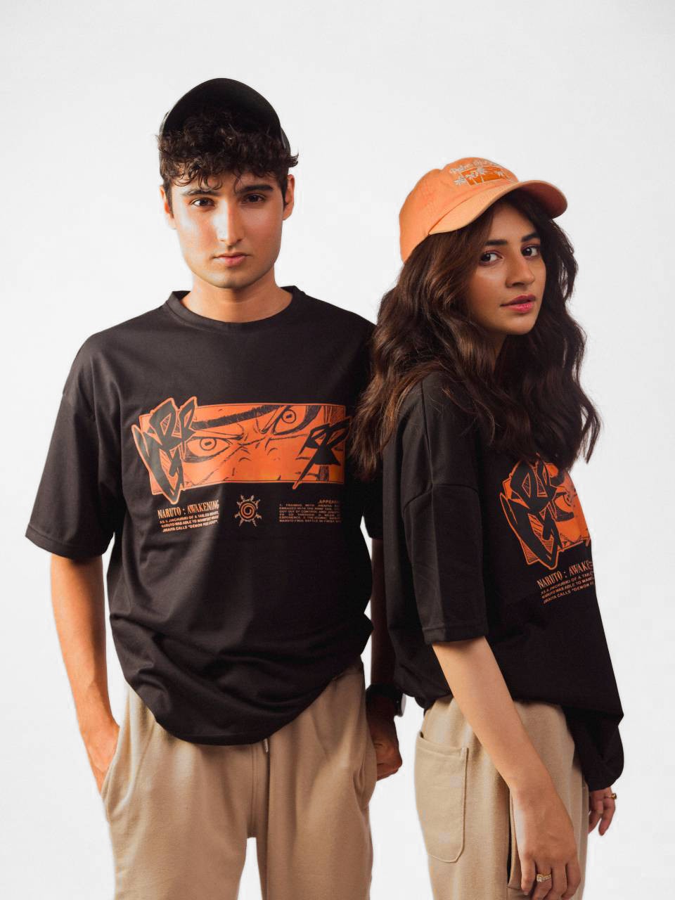 male and female model wearing black naruto awakening oversized graphic t shirt showing front and right side of the t shirt