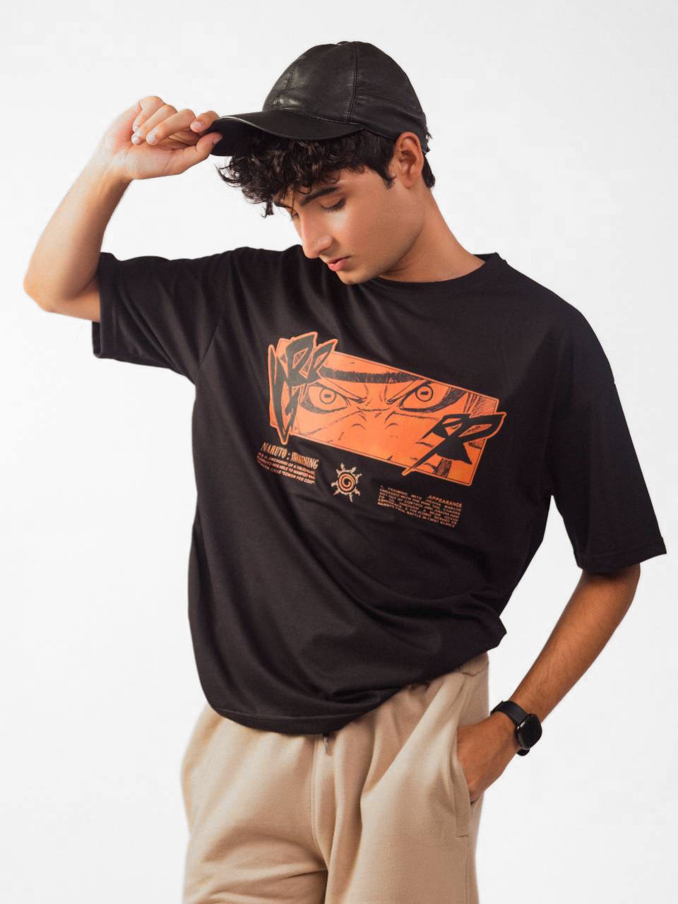 male model wearing black naruto awakening oversized graphic t shirt showing front side of the t shirt while standing