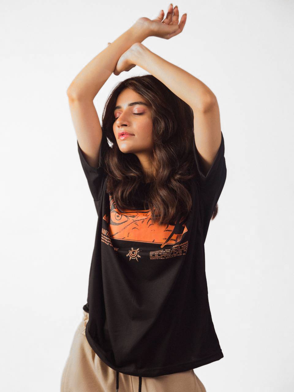 female model wearing black naruto awakening oversized graphic t shirt showing front side of the t shirt