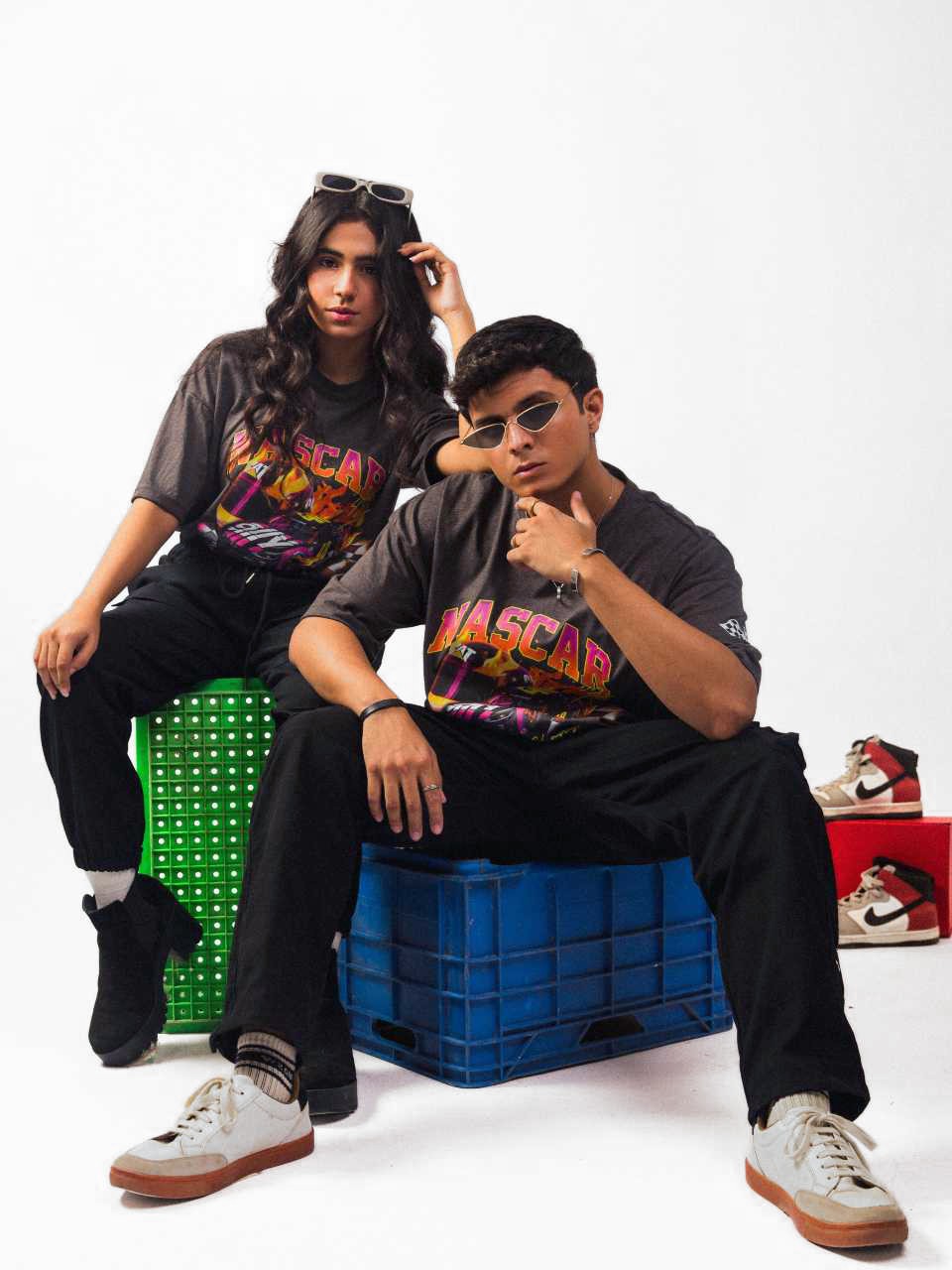 Male and female  model wearing charcoal nascar oversized graphic t shirt showing the front while sitting