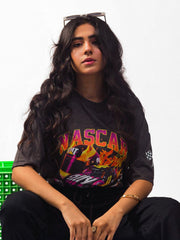 female model wearing charcoal nascar oversized graphic t shirt showing the front of the t shirt while sitting